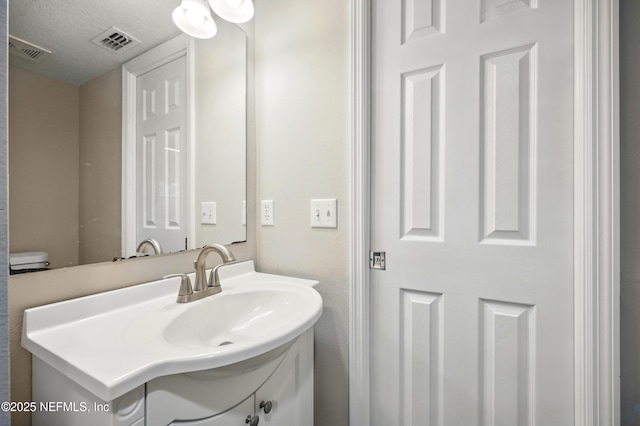 172 King Arthur Ct, Saint Augustine, FL 32086 - bathroom with vanity and a textured ceiling