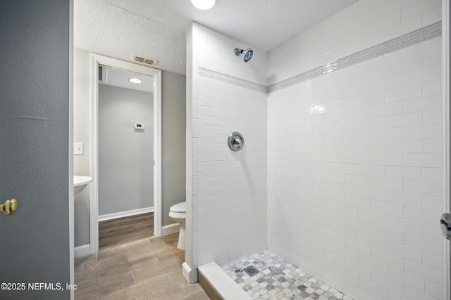 172 King Arthur Ct, Saint Augustine, FL 32086 - full bath featuring a shower stall, wood finished floors, toilet, and a textured ceiling
