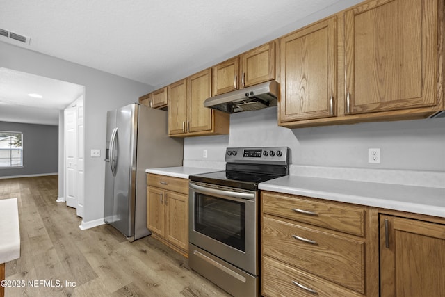 172 King Arthur Ct, Saint Augustine, FL 32086 - kitchen featuring under cabinet range hood, stainless steel appliances, light wood-style flooring, light countertops, and brown cabinets