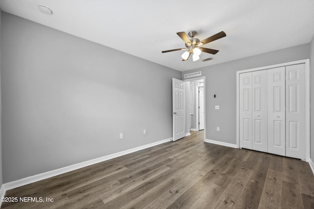 172 King Arthur Ct, Saint Augustine, FL 32086 - unfurnished bedroom with wood finished floors, baseboards, a closet, and ceiling fan