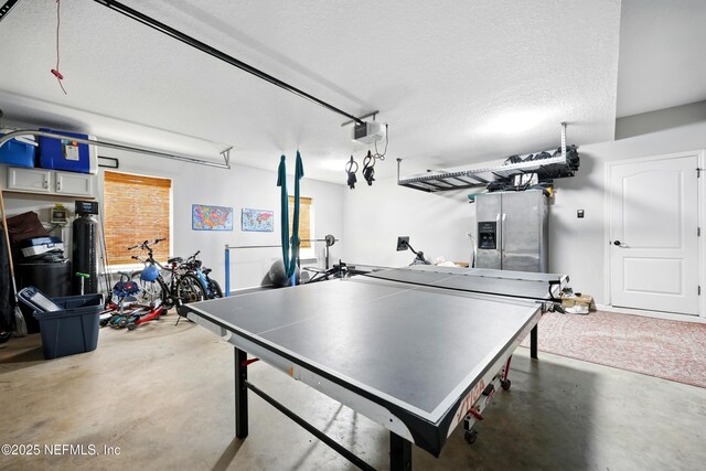 309 Elza Ln, Saint Augustine, FL 32086 - rec room featuring concrete floors, a garage, and a textured ceiling