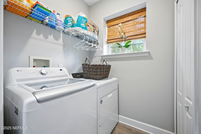 309 Elza Ln, Saint Augustine, FL 32086 - laundry area with separate washer and dryer, wood finished floors, and baseboards