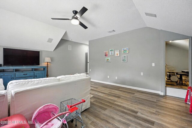 309 Elza Ln, Saint Augustine, FL 32086 - living room with vaulted ceiling, wood finished floors, a ceiling fan, a textured ceiling, and baseboards