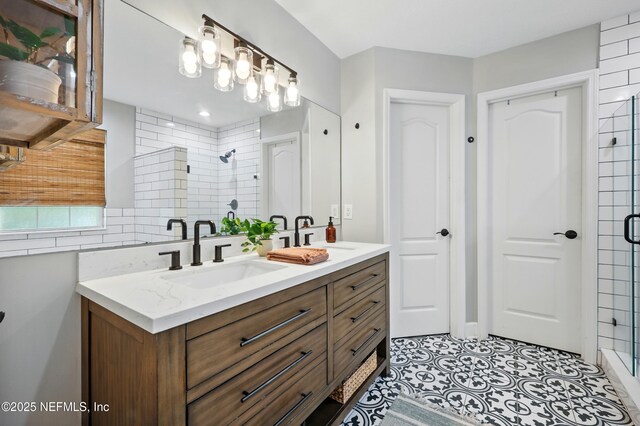 309 Elza Ln, Saint Augustine, FL 32086 - full bath featuring double vanity, a stall shower, and backsplash