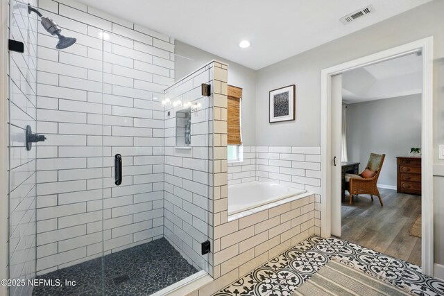 309 Elza Ln, Saint Augustine, FL 32086 - full bath featuring a shower stall, a garden tub, wood finished floors, recessed lighting, and baseboards
