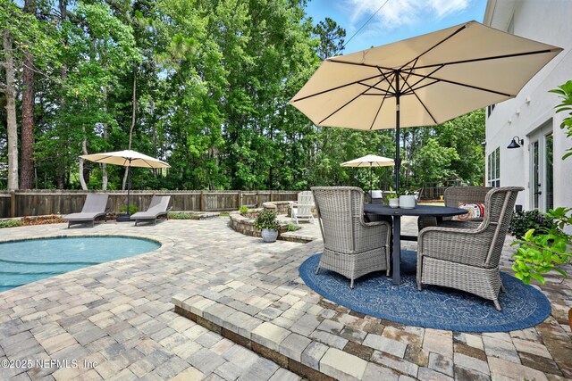 309 Elza Ln, Saint Augustine, FL 32086 - fenced backyard with a patio and outdoor dining space
