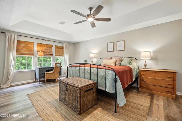 309 Elza Ln, Saint Augustine, FL 32086 - bedroom featuring a raised ceiling, wood finished floors, baseboards, a textured ceiling, and ceiling fan
