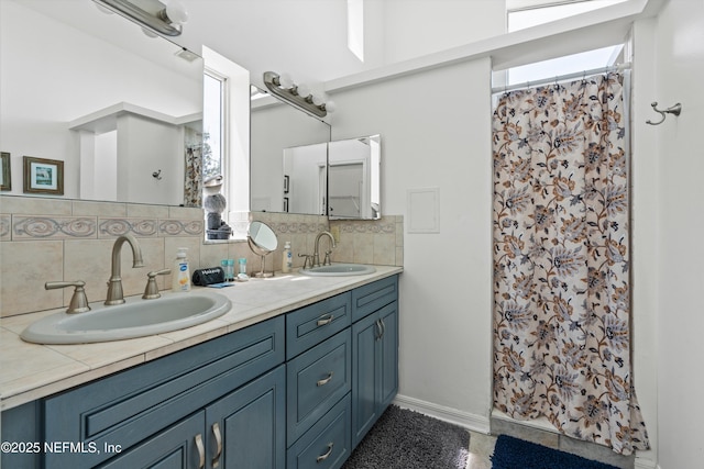 5473 Pelican Way, Saint Augustine, FL 32080 - full bath with double vanity, decorative backsplash, curtained shower, and baseboards
