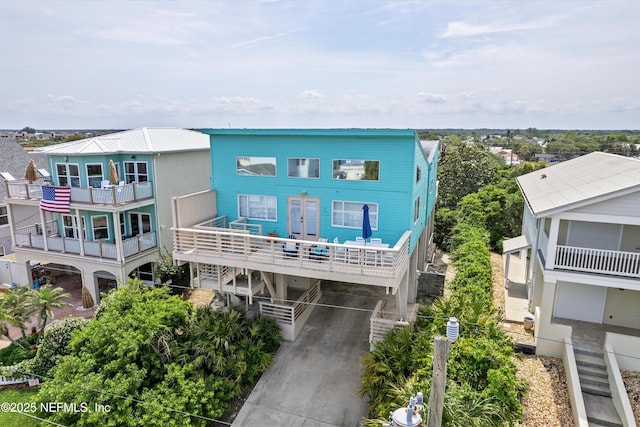 5473 Pelican Way, Saint Augustine, FL 32080 - raised beach house featuring a carport, a balcony, and driveway