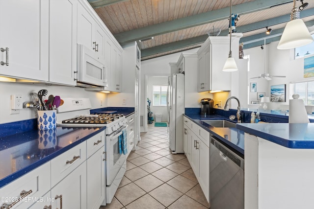 5473 Pelican Way, Saint Augustine, FL 32080 - kitchen with white appliances, a sink, dark countertops, white cabinetry, and wooden ceiling with exposed beams