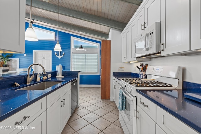 5473 Pelican Way, Saint Augustine, FL 32080 - kitchen with white appliances, a sink, white cabinets, light tile patterned flooring, and beamed ceiling