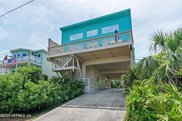 5473 Pelican Way, Saint Augustine, FL 32080 - raised beach house featuring a carport, driveway, and a balcony