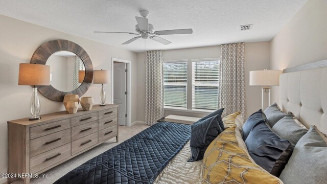 6951 Gable Grove Ave, Jacksonville, FL 32217 - bedroom with light carpet, a textured ceiling, a ceiling fan, and baseboards