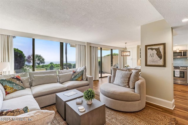 1185 Beach Walker Rd Unit 1185, Fernandina Beach, FL 32034 - living area featuring wood finished floors, baseboards, a textured ceiling, and a chandelier