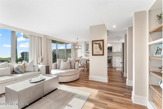 1185 Beach Walker Rd Unit 1185, Fernandina Beach, FL 32034 - living room featuring light wood-style floors, baseboards, a chandelier, and recessed lighting