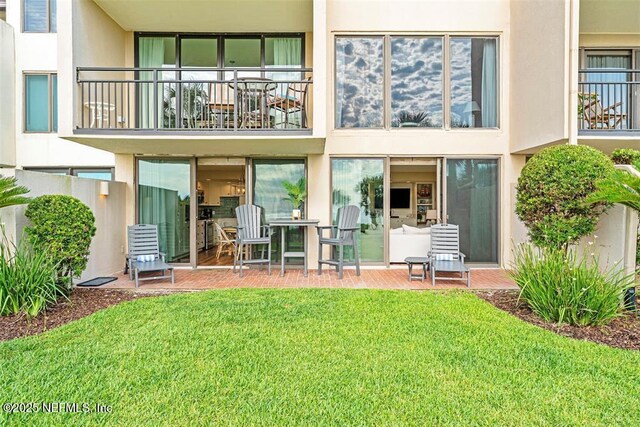 1185 Beach Walker Rd Unit 1185, Fernandina Beach, FL 32034 - back of property with stucco siding and a lawn