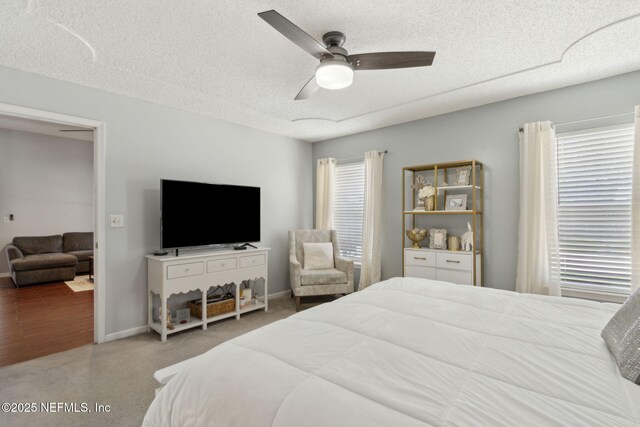 2000 Belhaven Dr, Orange Park, FL 32065 - bedroom featuring a textured ceiling, baseboards, a ceiling fan, and carpet flooring