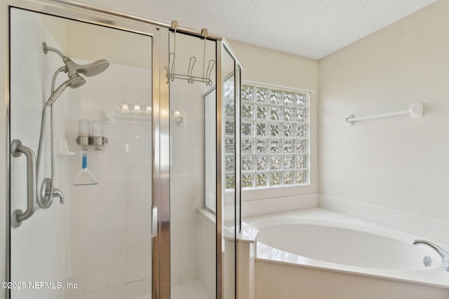 2000 Belhaven Dr, Orange Park, FL 32065 - bathroom with a garden tub, a stall shower, and a textured ceiling