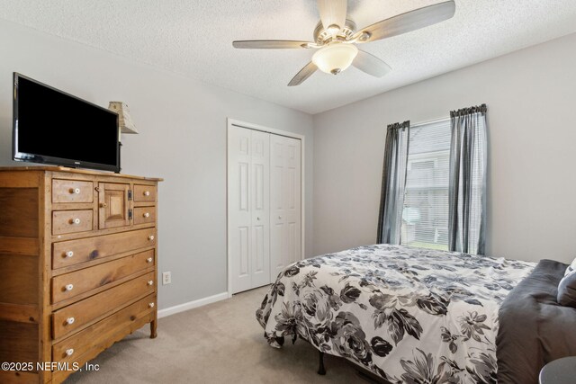 2000 Belhaven Dr, Orange Park, FL 32065 - bedroom with light colored carpet, a closet, a textured ceiling, a ceiling fan, and baseboards