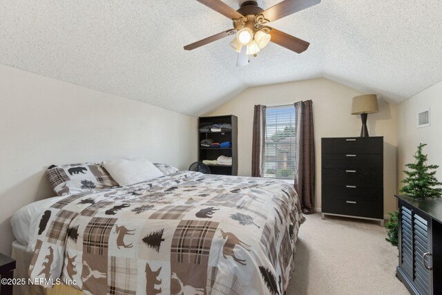 2000 Belhaven Dr, Orange Park, FL 32065 - bedroom with light carpet, vaulted ceiling, a textured ceiling, and a ceiling fan