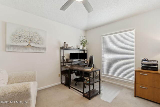 2000 Belhaven Dr, Orange Park, FL 32065 - home office with baseboards, light colored carpet, a ceiling fan, a textured ceiling, and healthy amount of natural light