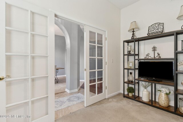 2000 Belhaven Dr, Orange Park, FL 32065 - unfurnished office featuring french doors, arched walkways, tile patterned floors, and baseboards