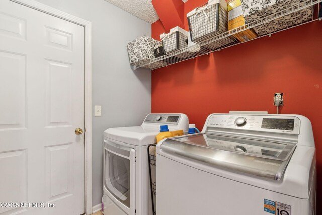 2000 Belhaven Dr, Orange Park, FL 32065 - laundry room featuring separate washer and dryer and a textured ceiling