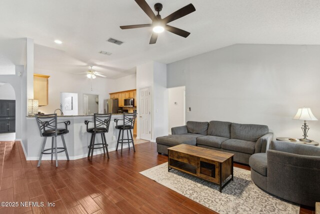 2000 Belhaven Dr, Orange Park, FL 32065 - living area featuring ceiling fan, vaulted ceiling, wood finished floors, and baseboards