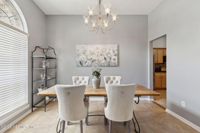 2000 Belhaven Dr, Orange Park, FL 32065 - dining space with a chandelier, baseboards, and light tile patterned floors