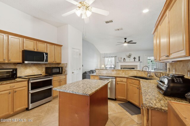 2000 Belhaven Dr, Orange Park, FL 32065 - kitchen with appliances with stainless steel finishes, ceiling fan, a sink, decorative backsplash, and lofted ceiling