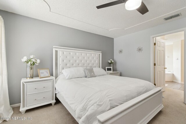2000 Belhaven Dr, Orange Park, FL 32065 - carpeted bedroom featuring a textured ceiling, a ceiling fan, and ensuite bath