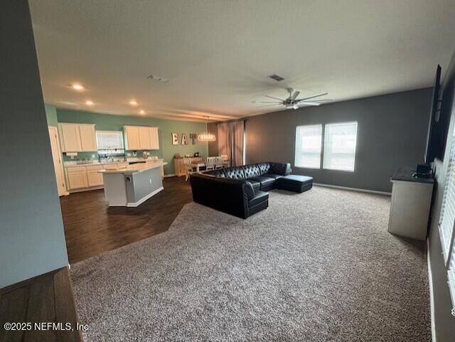 2358 Evening Oaks Ln, Green Cove Springs, FL 32043 - living room with dark colored carpet, a ceiling fan, recessed lighting, and baseboards