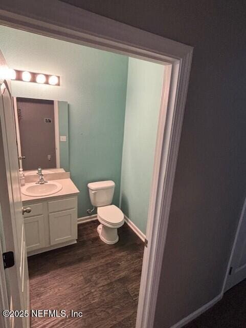2358 Evening Oaks Ln, Green Cove Springs, FL 32043 - bathroom with vanity, toilet, wood finished floors, and baseboards