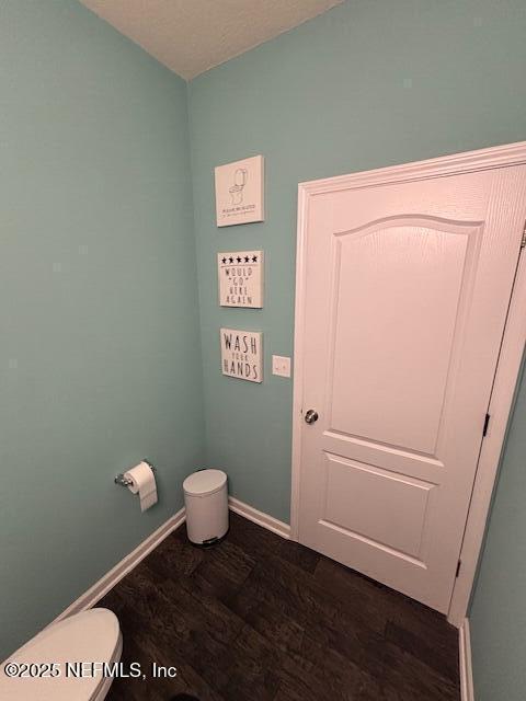 2358 Evening Oaks Ln, Green Cove Springs, FL 32043 - bathroom featuring wood finished floors, toilet, and baseboards