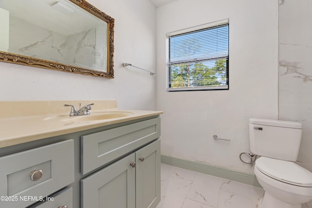 3747 Copper Cir E, Jacksonville, FL 32207 - bathroom with marble finish floors, vanity, toilet, and baseboards