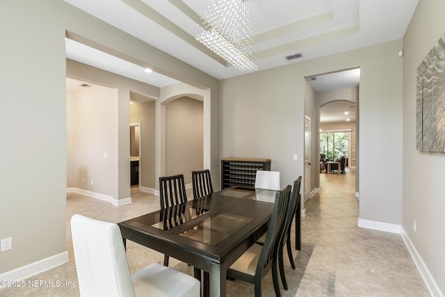 117 S Durbin Pkwy, Saint Johns, FL 32259 - dining area with arched walkways, a tray ceiling, light tile patterned floors, a chandelier, and recessed lighting