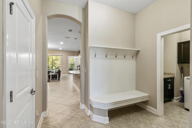 117 S Durbin Pkwy, Saint Johns, FL 32259 - mudroom with arched walkways, light tile patterned floors, and baseboards