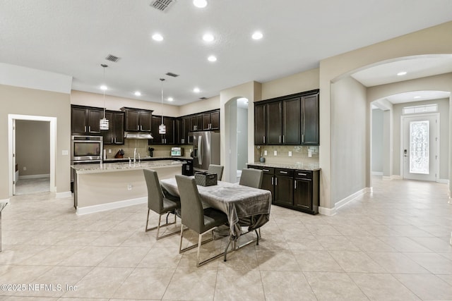 117 S Durbin Pkwy, Saint Johns, FL 32259 - dining space featuring arched walkways, light tile patterned flooring, recessed lighting, and baseboards