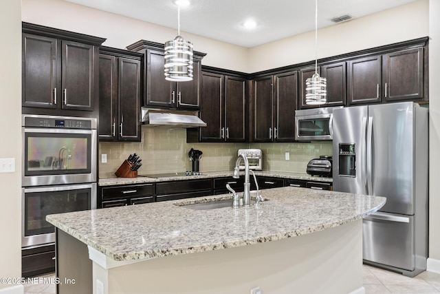 117 S Durbin Pkwy, Saint Johns, FL 32259 - kitchen with appliances with stainless steel finishes, a sink, under cabinet range hood, light tile patterned floors, and backsplash