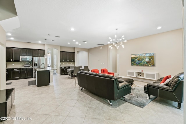 117 S Durbin Pkwy, Saint Johns, FL 32259 - living room with a chandelier, recessed lighting, light tile patterned floors, and arched walkways