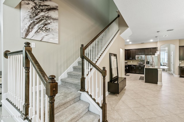 117 S Durbin Pkwy, Saint Johns, FL 32259 - stairs featuring tile patterned flooring, arched walkways, baseboards, and recessed lighting