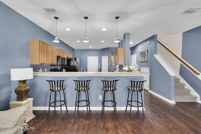 3690 Creswick Cir Unit G, Orange Park, FL 32065 - kitchen with freestanding refrigerator, black microwave, a peninsula, dark wood-style floors, and recessed lighting