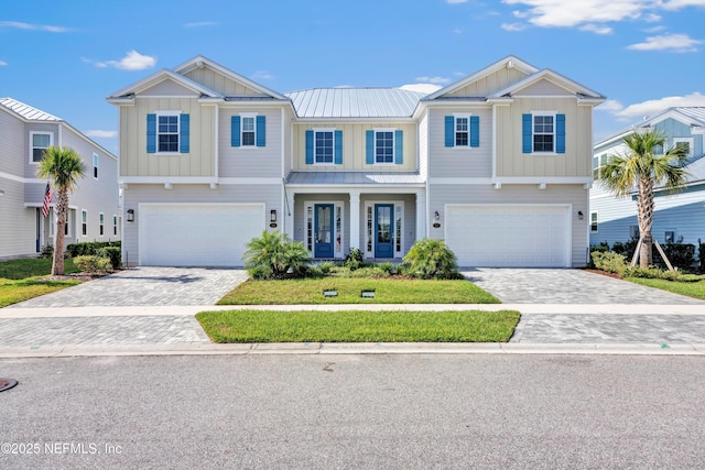 329 Rum Runner Way, Saint Johns, FL 32259 - view of front of home featuring board and batten siding, an attached garage, and decorative driveway