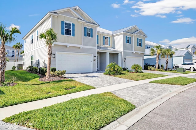 329 Rum Runner Way, Saint Johns, FL 32259 - view of front of house featuring board and batten siding, an attached garage, decorative driveway, a residential view, and a front lawn