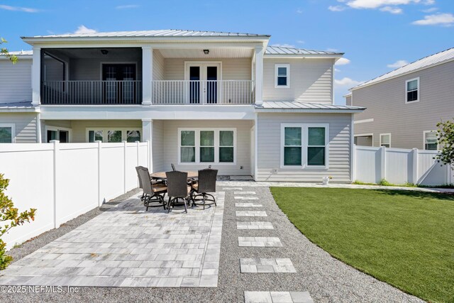 329 Rum Runner Way, Saint Johns, FL 32259 - rear view of property featuring a patio, metal roof, a balcony, a standing seam roof, and french doors