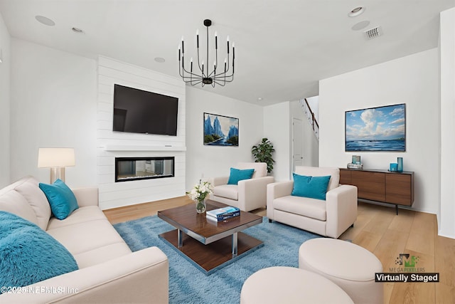 329 Rum Runner Way, Saint Johns, FL 32259 - living area featuring light wood-type flooring, a chandelier, and a large fireplace