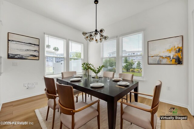 329 Rum Runner Way, Saint Johns, FL 32259 - dining room featuring a chandelier, light wood-style floors, and baseboards