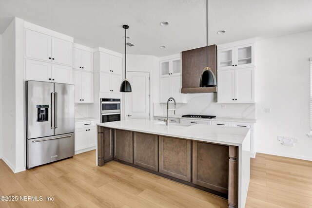 329 Rum Runner Way, Saint Johns, FL 32259 - kitchen featuring stainless steel appliances, a sink, white cabinets, light wood-style floors, and glass insert cabinets