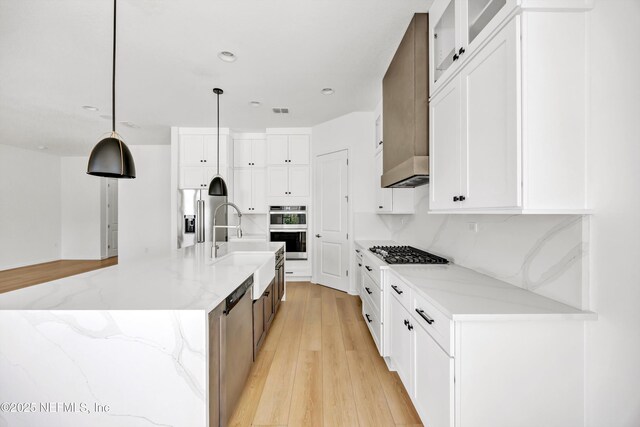 329 Rum Runner Way, Saint Johns, FL 32259 - kitchen with appliances with stainless steel finishes, a sink, white cabinetry, light stone counters, and recessed lighting