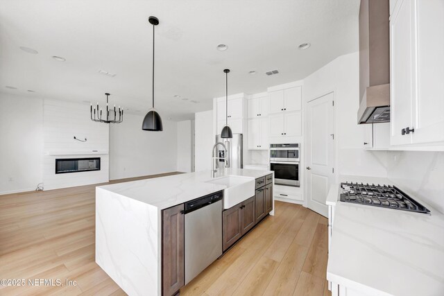 329 Rum Runner Way, Saint Johns, FL 32259 - kitchen with stainless steel appliances, a sink, light wood-style floors, white cabinets, and recessed lighting